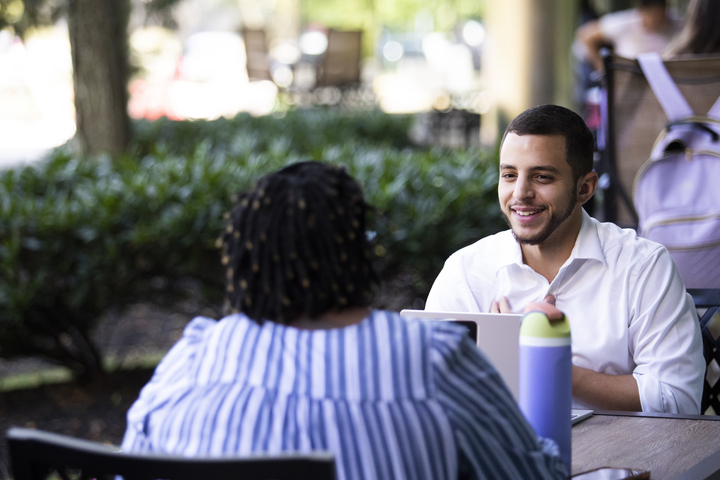 Adam Perez sitting with patient