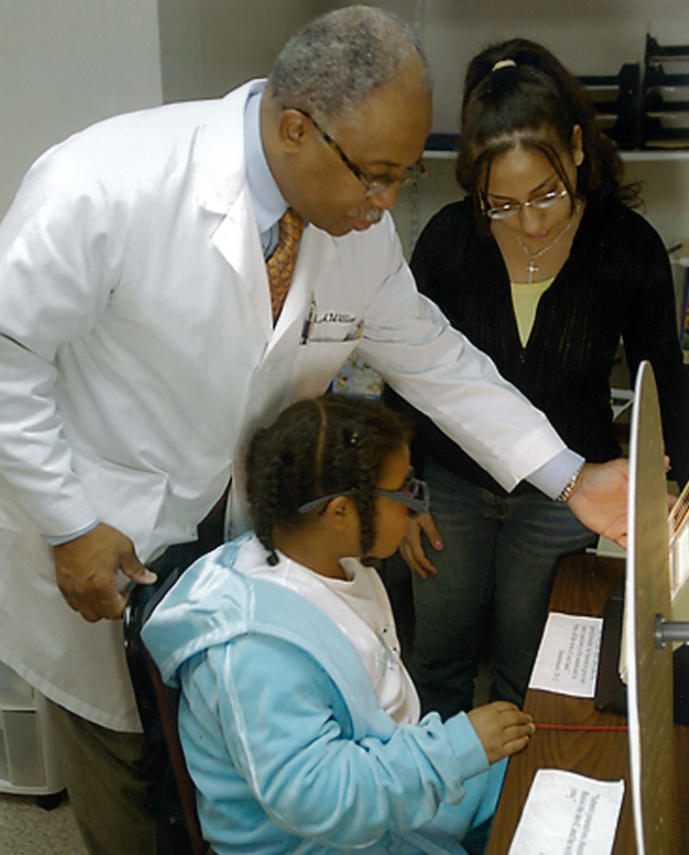 Dr. Williams in the exam room with two young patients