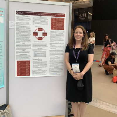 Andrea Tsyzka in front of poster presentation