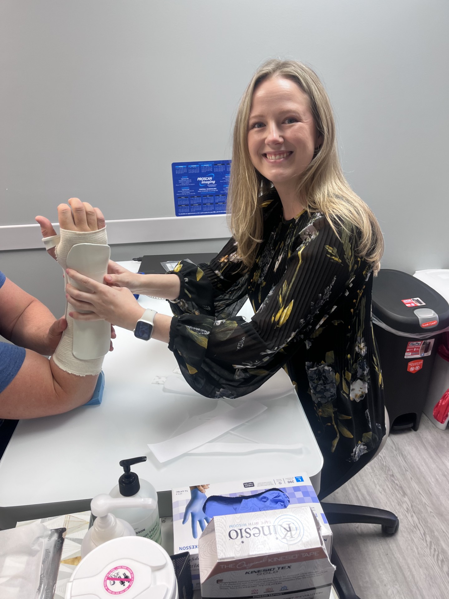 Ashley Kinton helping a hand patient