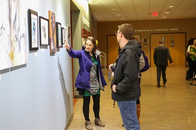 Artist pointing to a painting