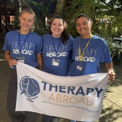 Three student holding Therapy Abroad flag thumbpic