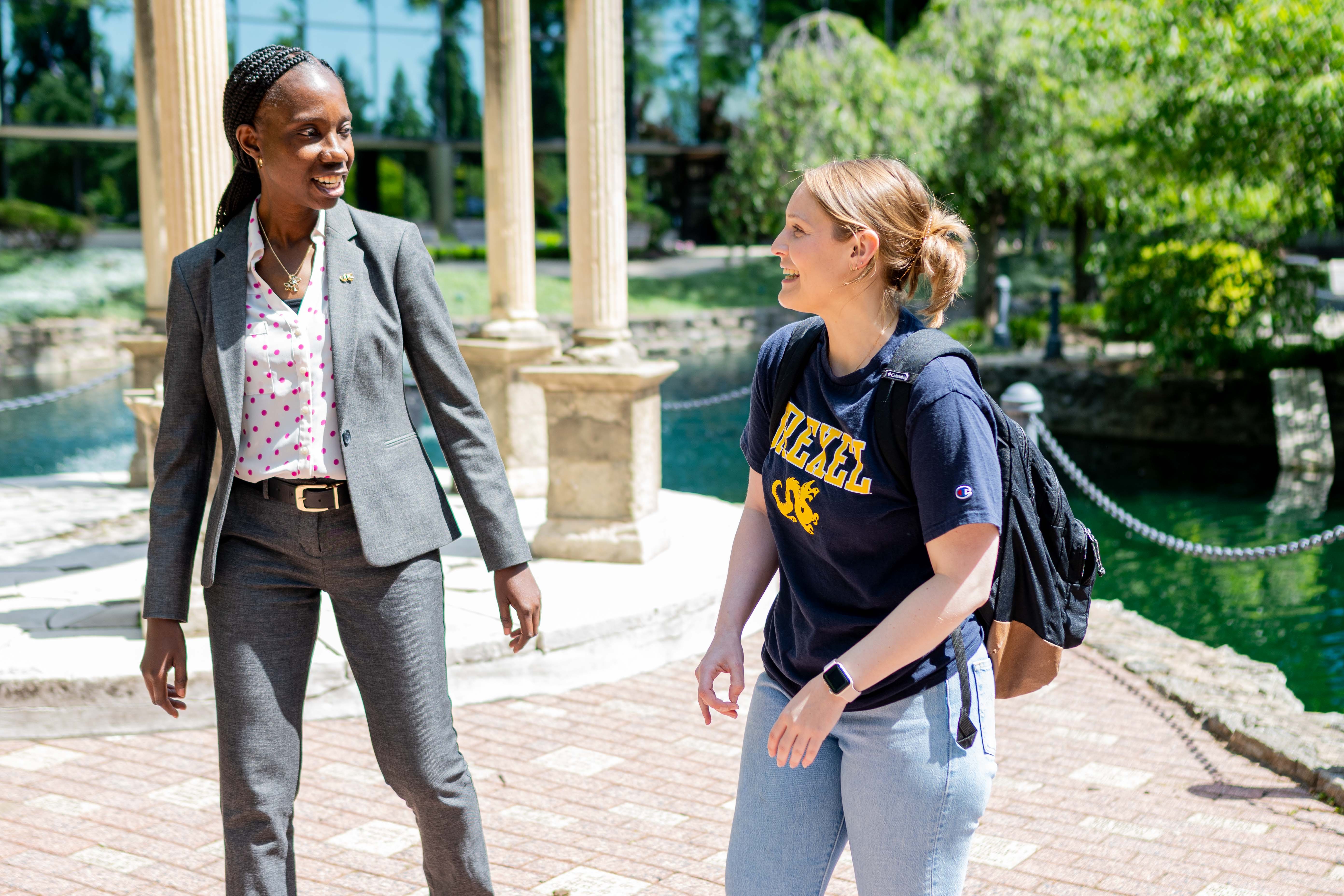 Dr. Ibironke and alum Maddy Edwards walk on campus