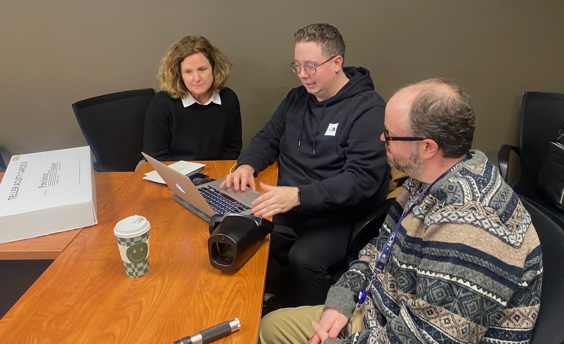 Christine McBennett and colleagues in conference room