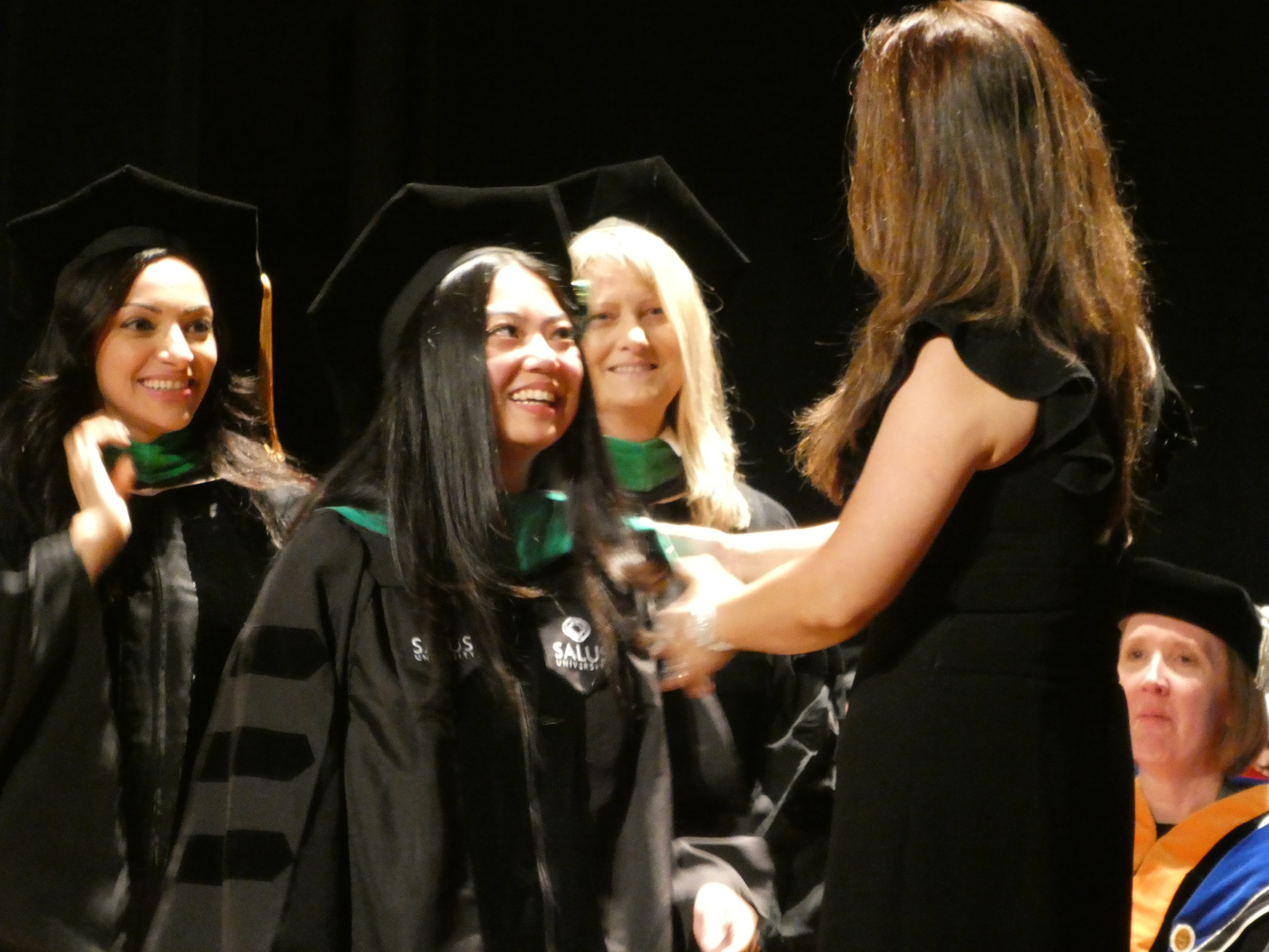 Happy graduate after getting her hood