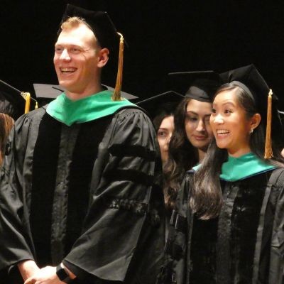 Two graduates at commencement thumbpic1