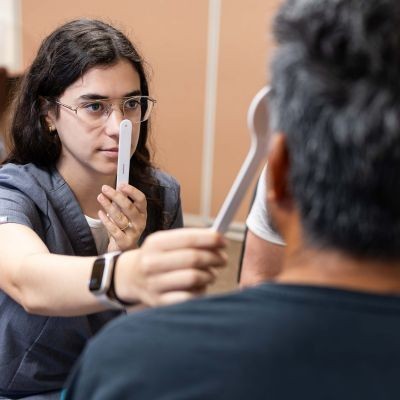 Student examines patient thumbpic