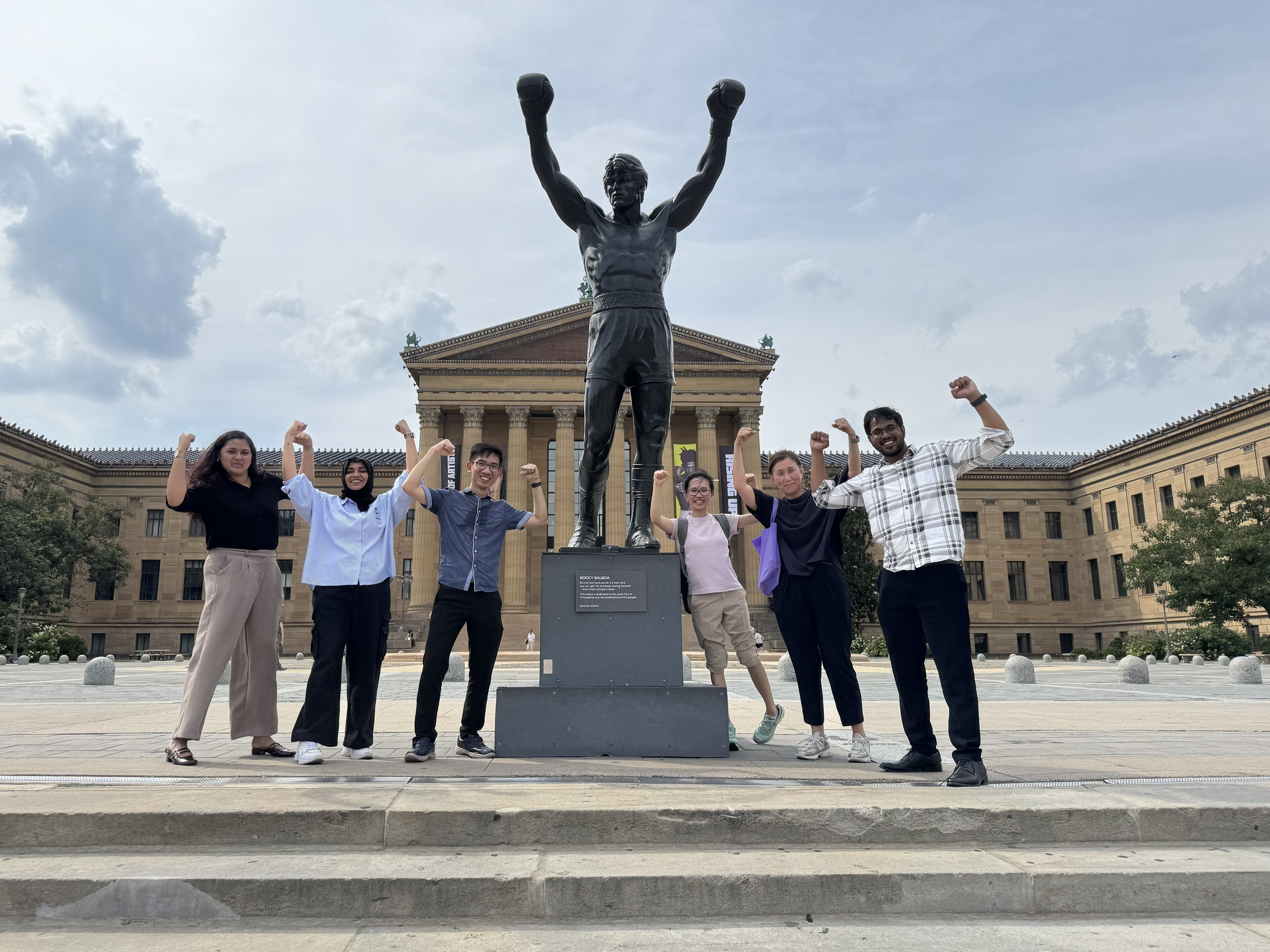 AUD Distance Ed students pose by the Rocky statue in Philly