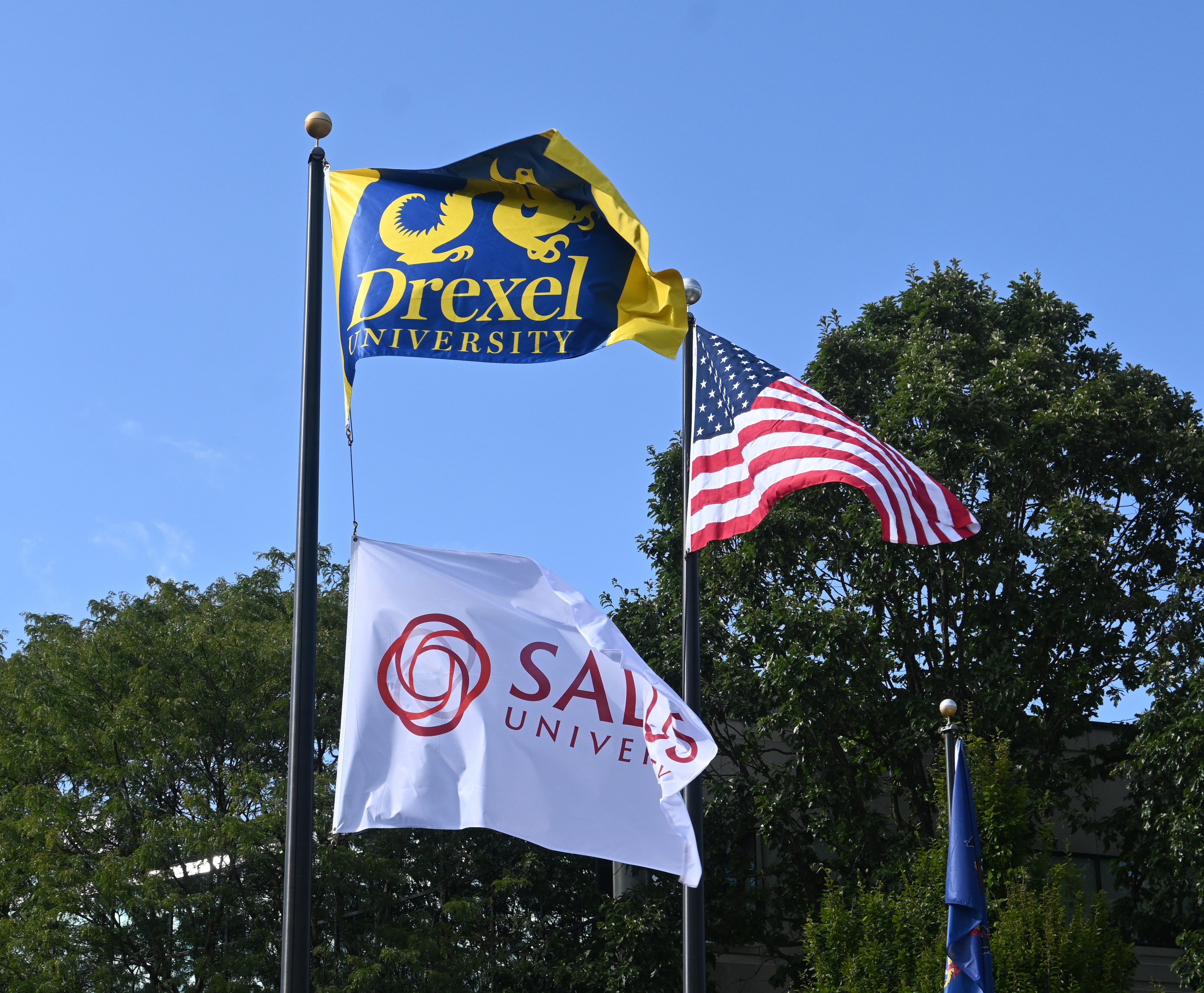 Drexel, Salus and U.S. flags on flagpoles
