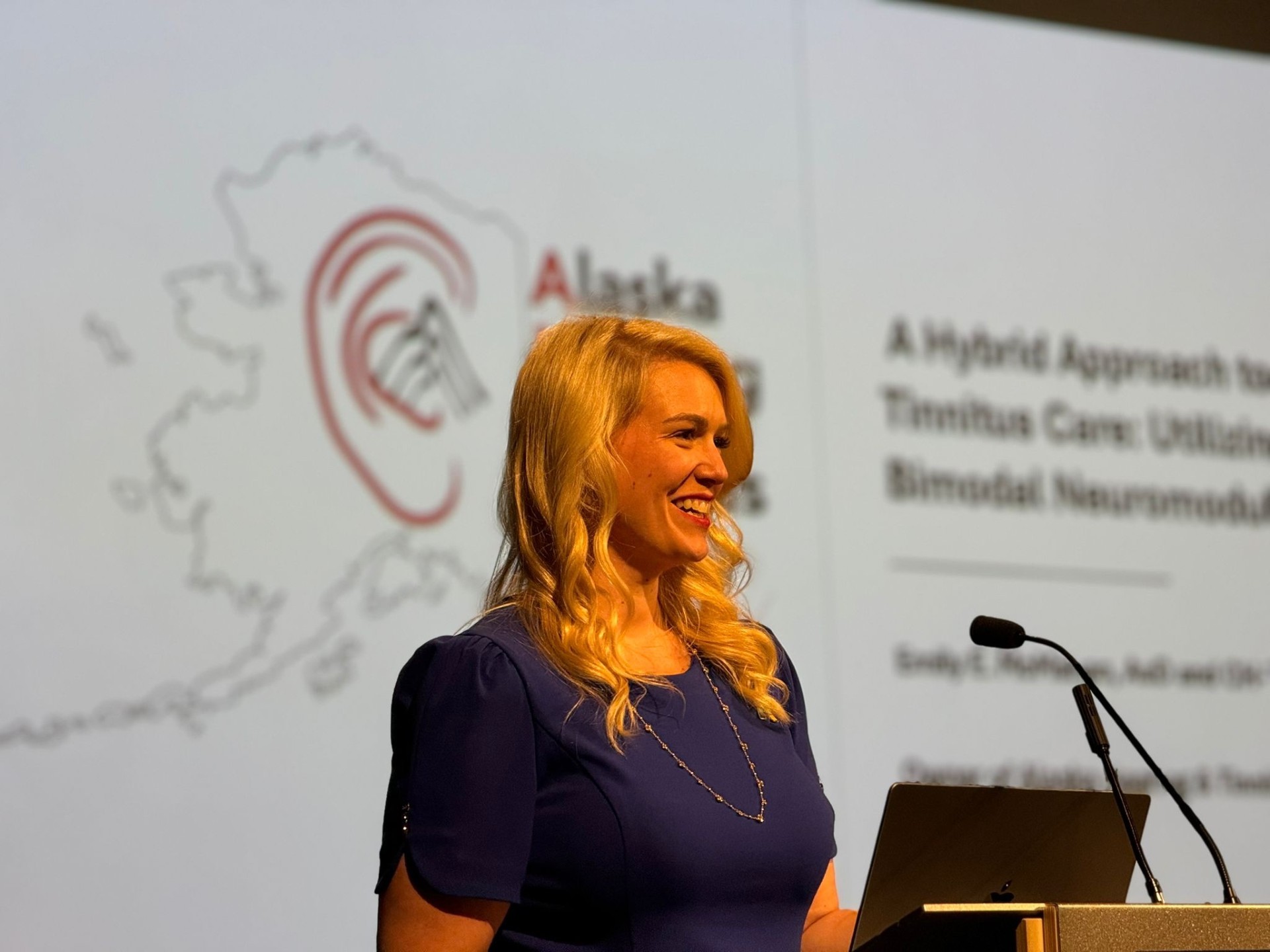 Emily McMahan at the podium during conference