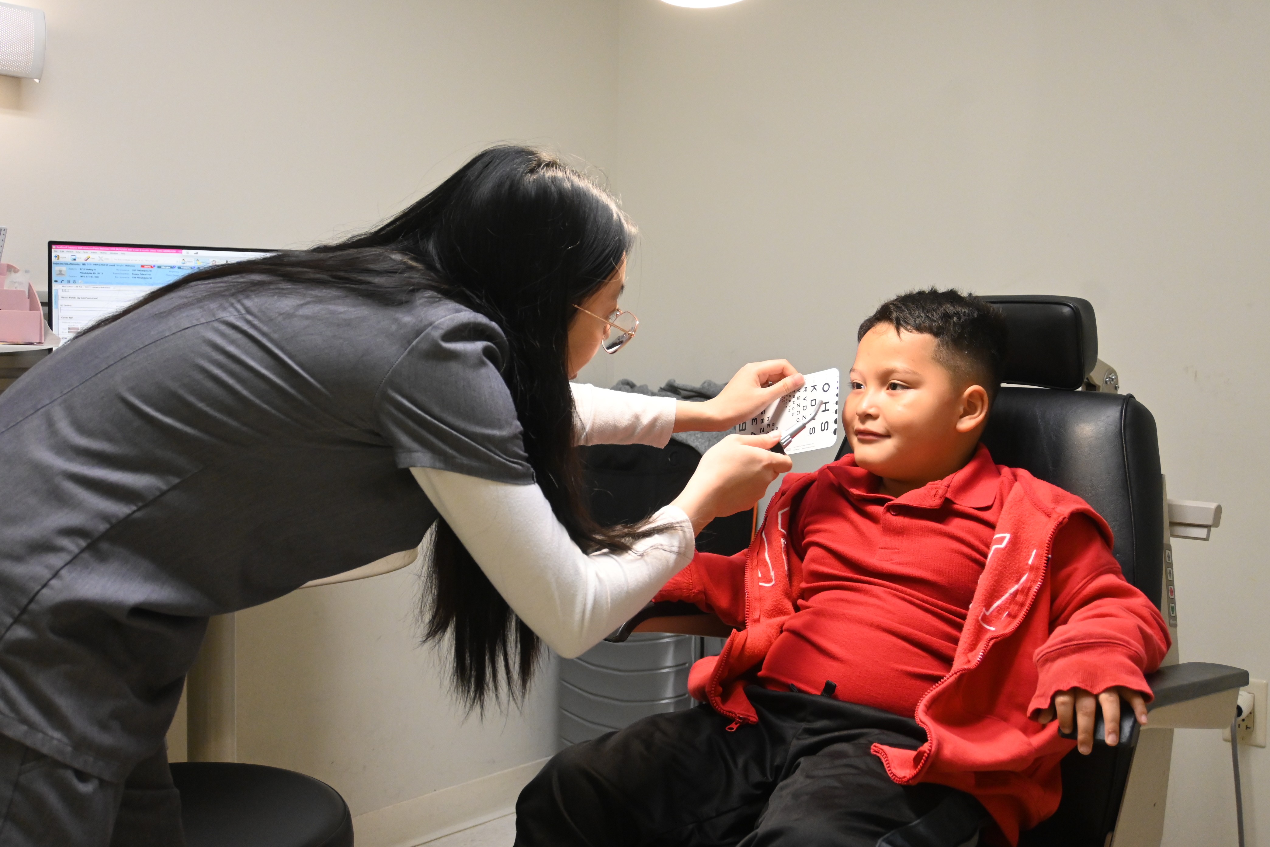 One optometric intern examining a child 
