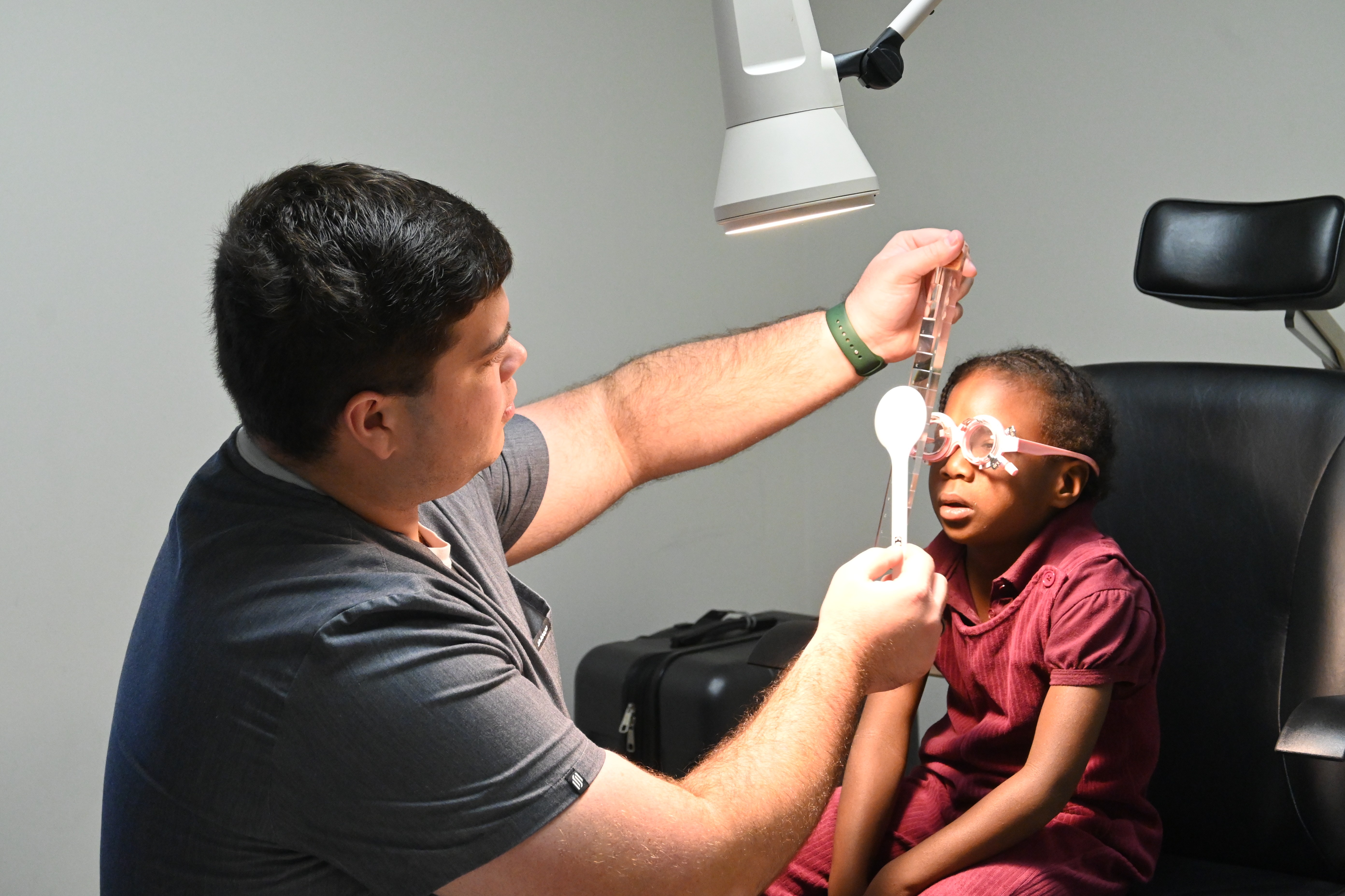 Optometric intern examining a child 