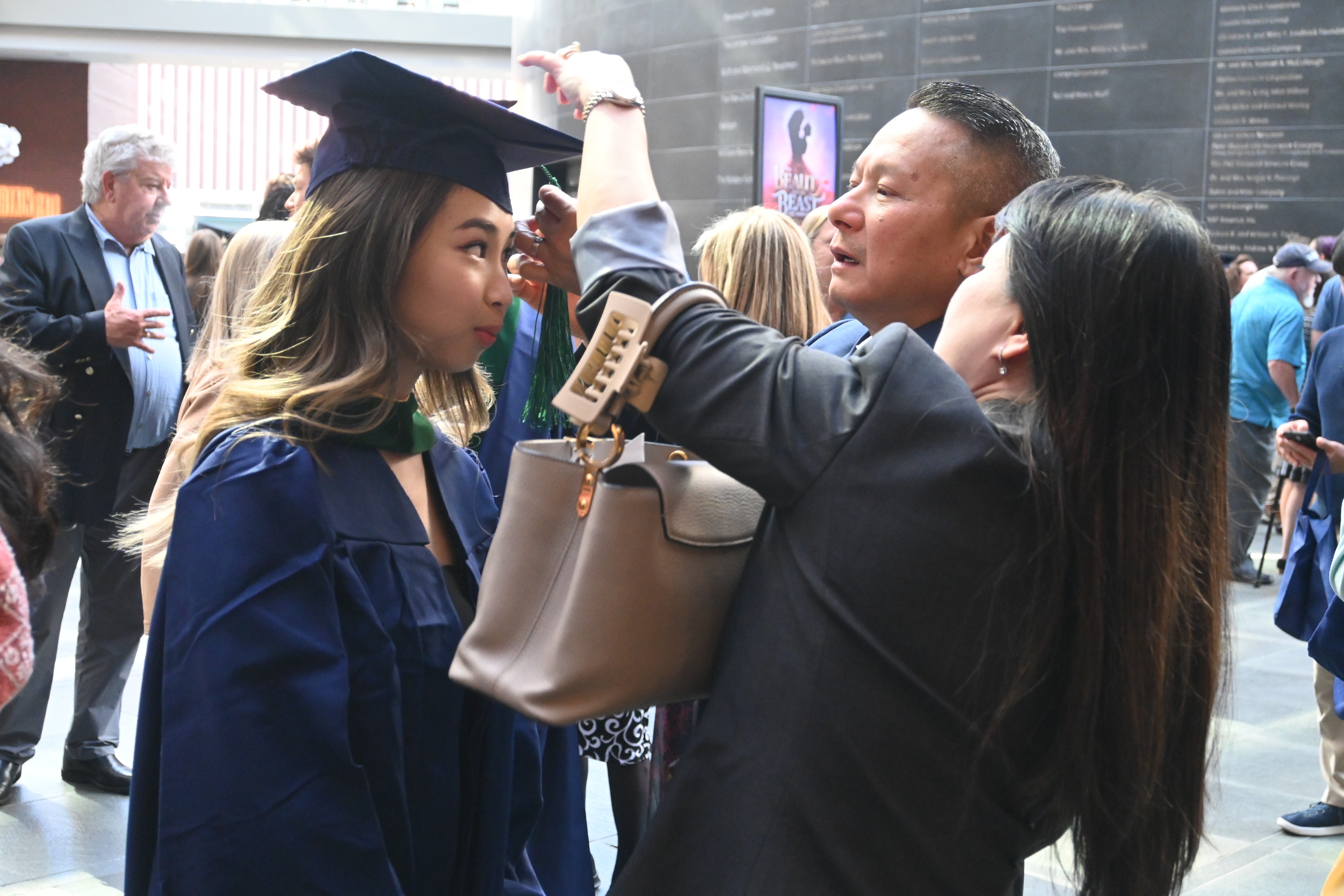 Graduate gets cap adjusted by parents pic7