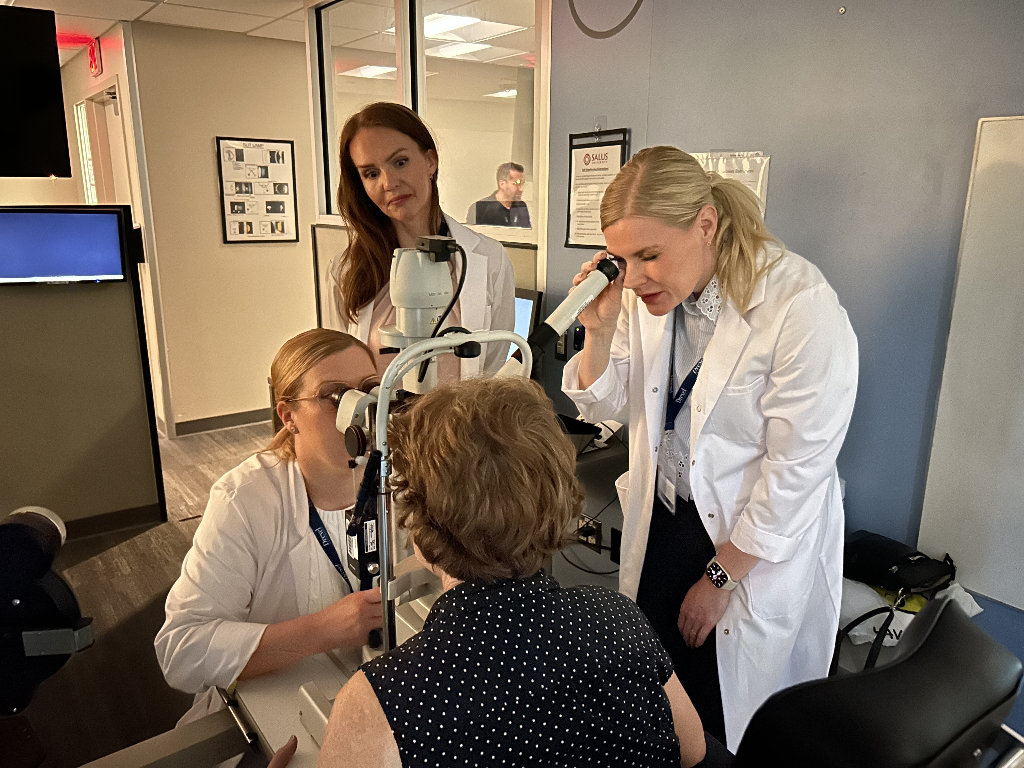 Three Finnish students examine patient in the lab 