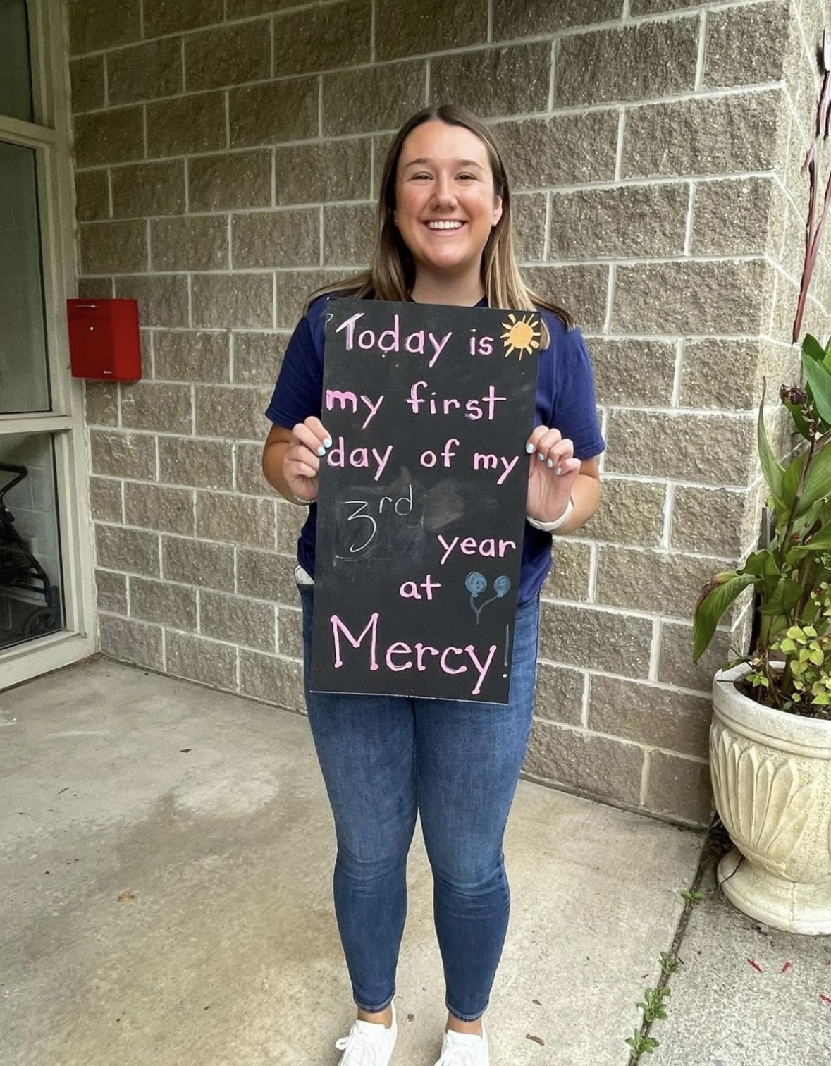 Kiersten holding a chalkboard sign