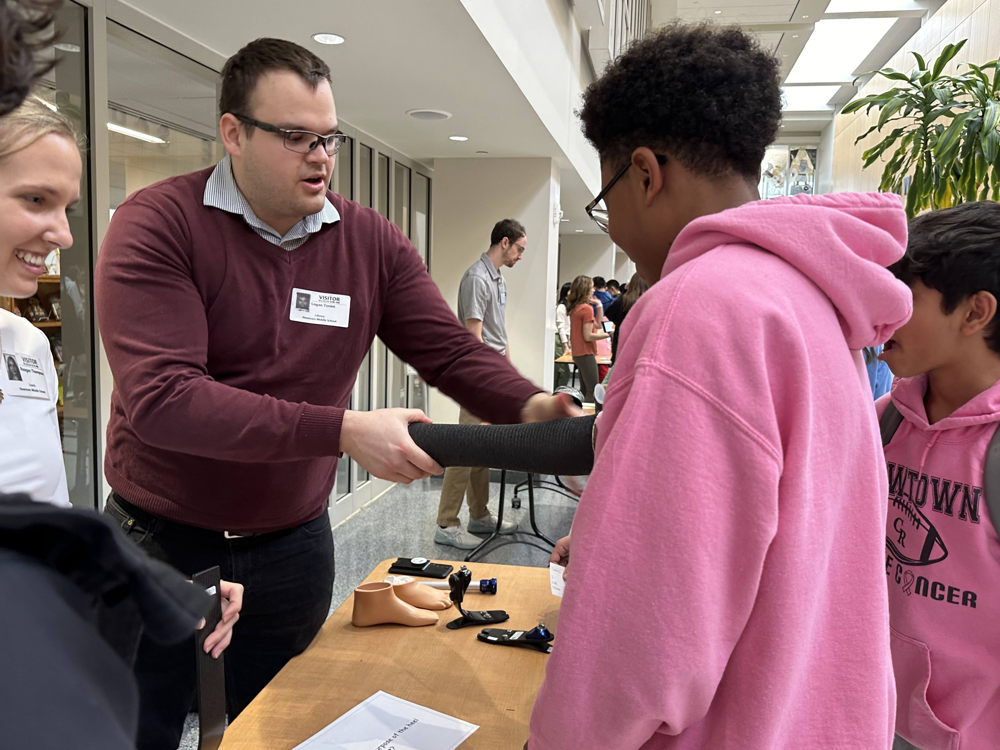 Logan Tonini helps an O&P client