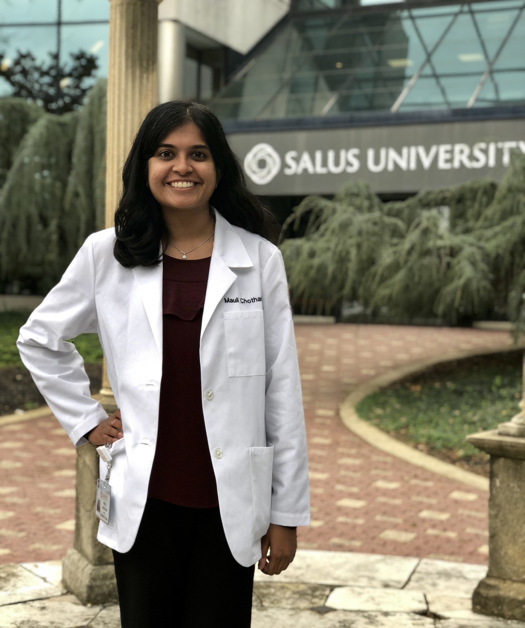 Mauli Chothani in white coat outside Salus