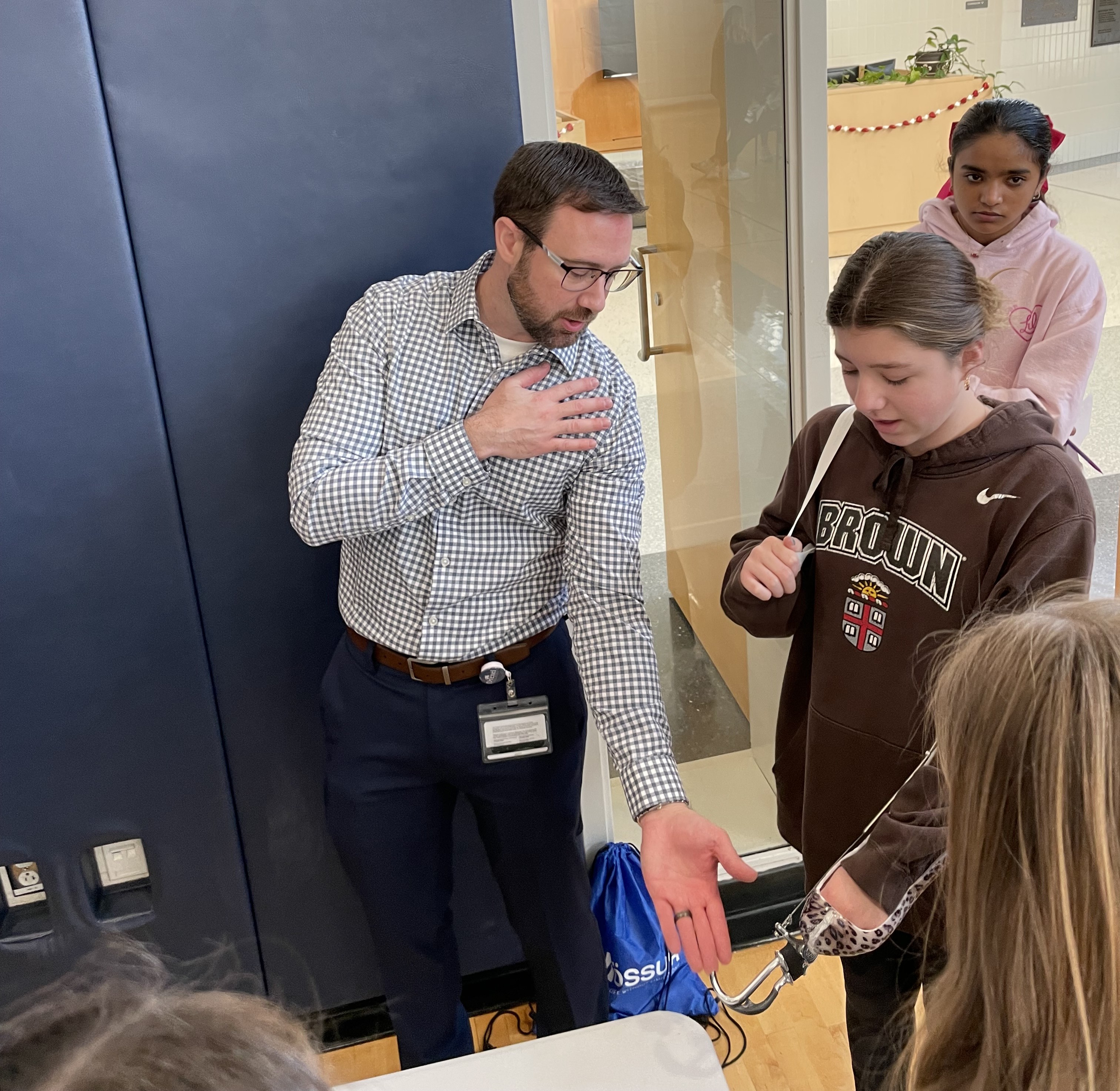 O&P student shows Newtown student how to use prosthetic