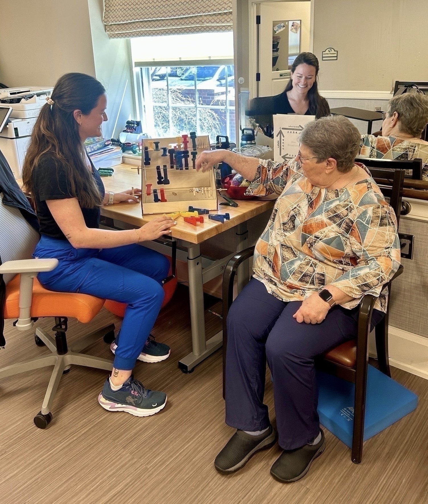 Olivia Gorski OT working with a patient