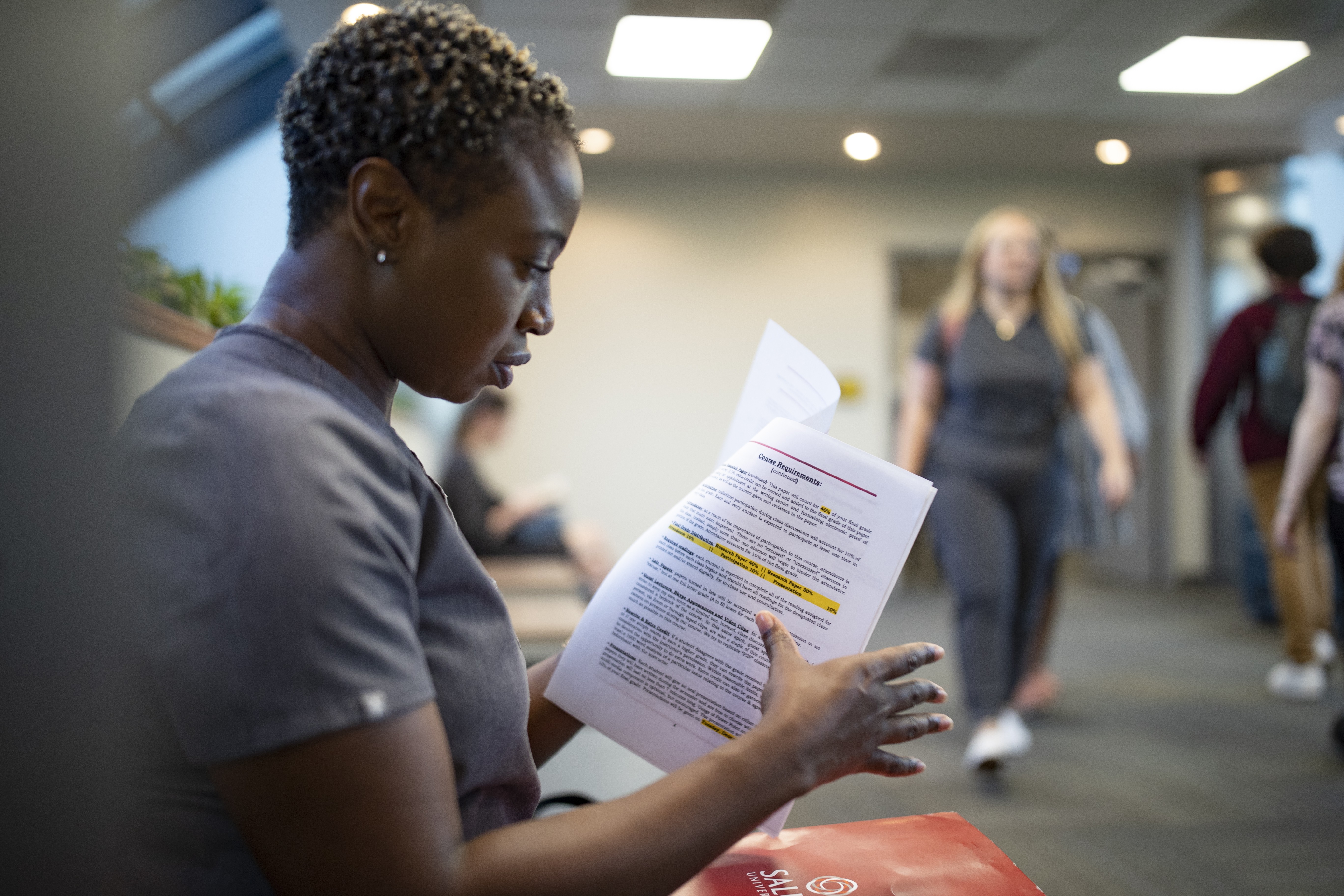 Student going over paperwork in the hallway pic3
