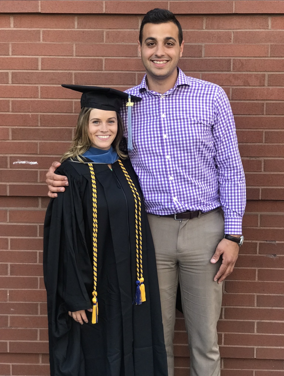 Rachel Picciotto in cap and gown with husband