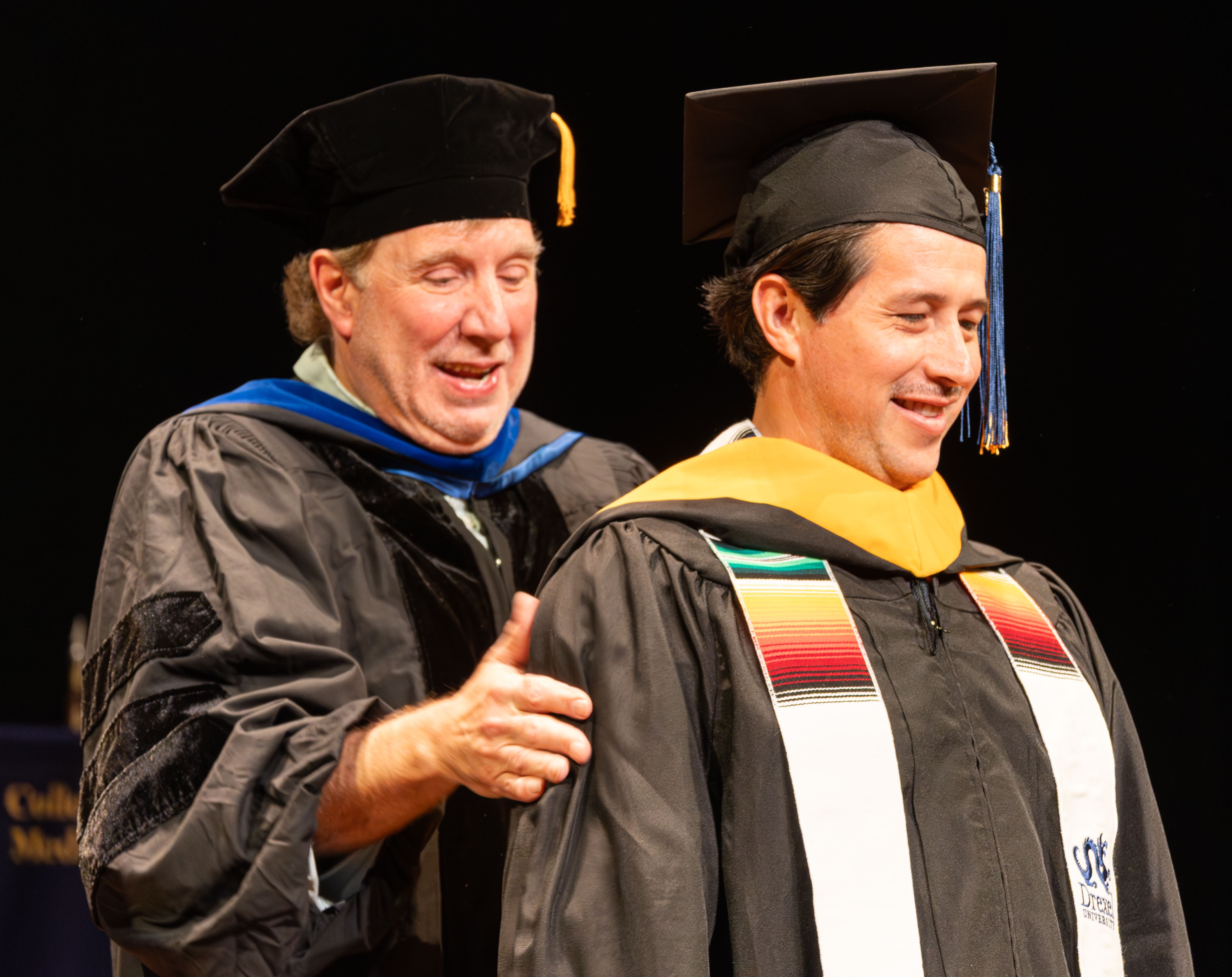 Ricardo getting hooded at commencement