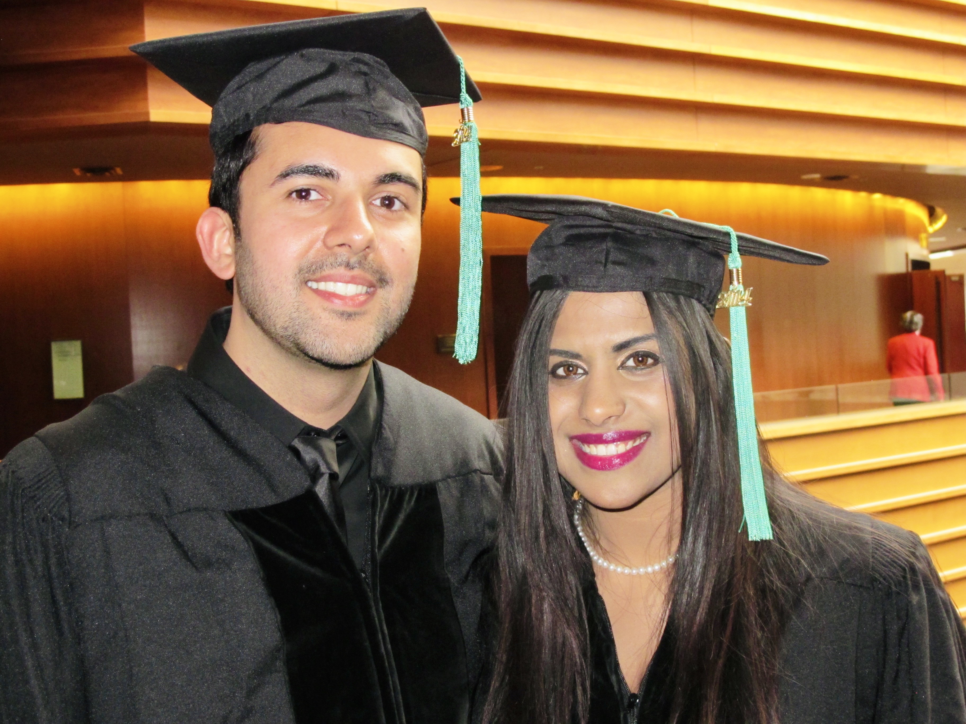 Riya and Rohit in cap and gown at commencement