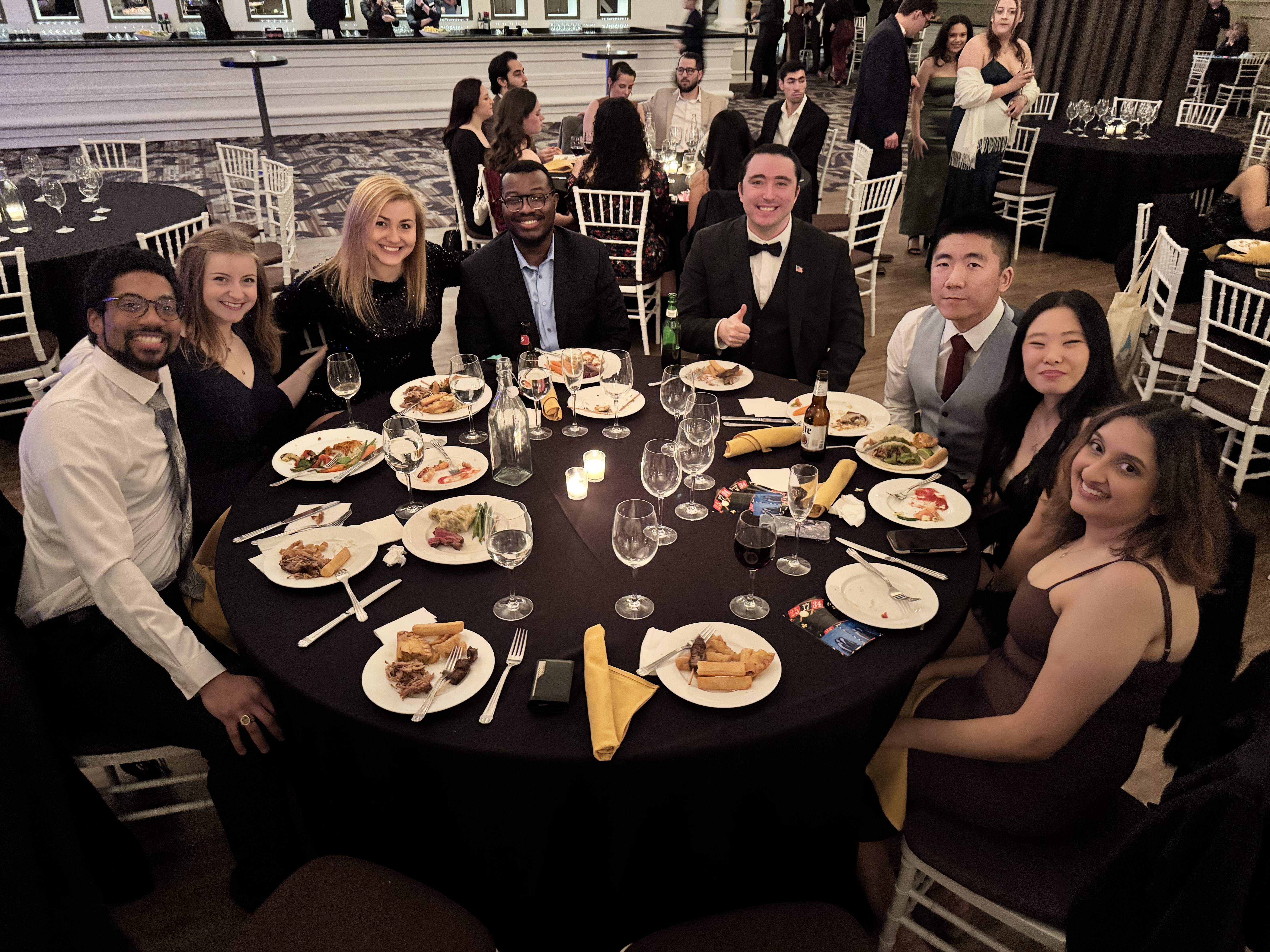 Soiree attendees around a banquet table