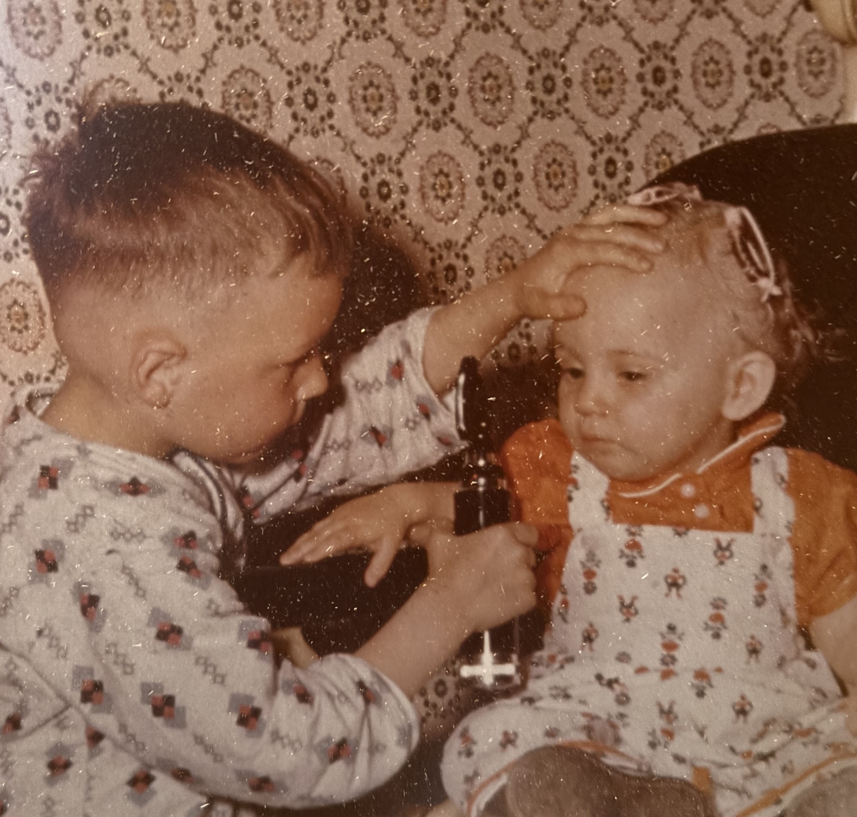 Young optometrist does eye exam on sister pic
