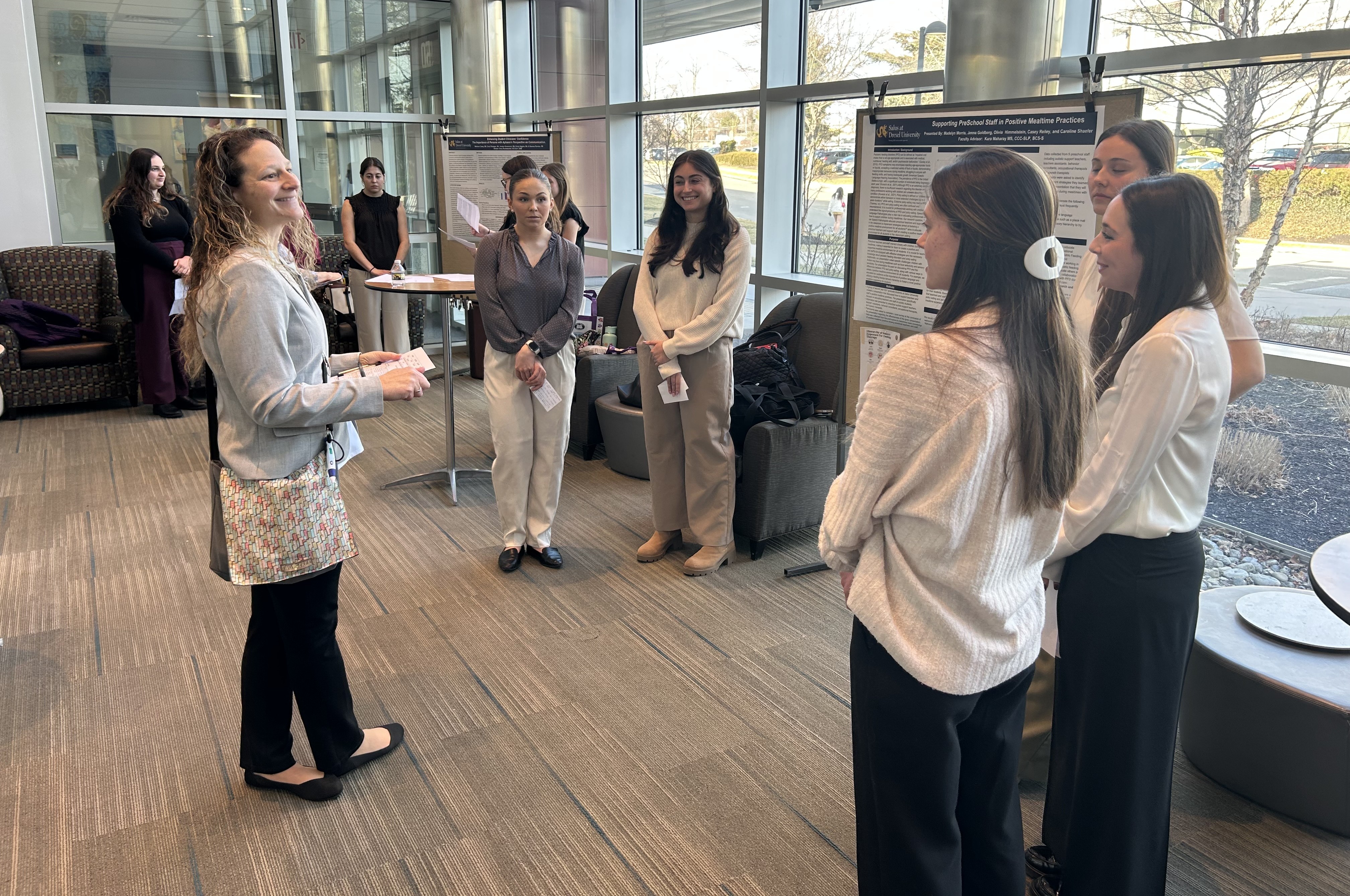 Faculty member inspects SLP Capstone project