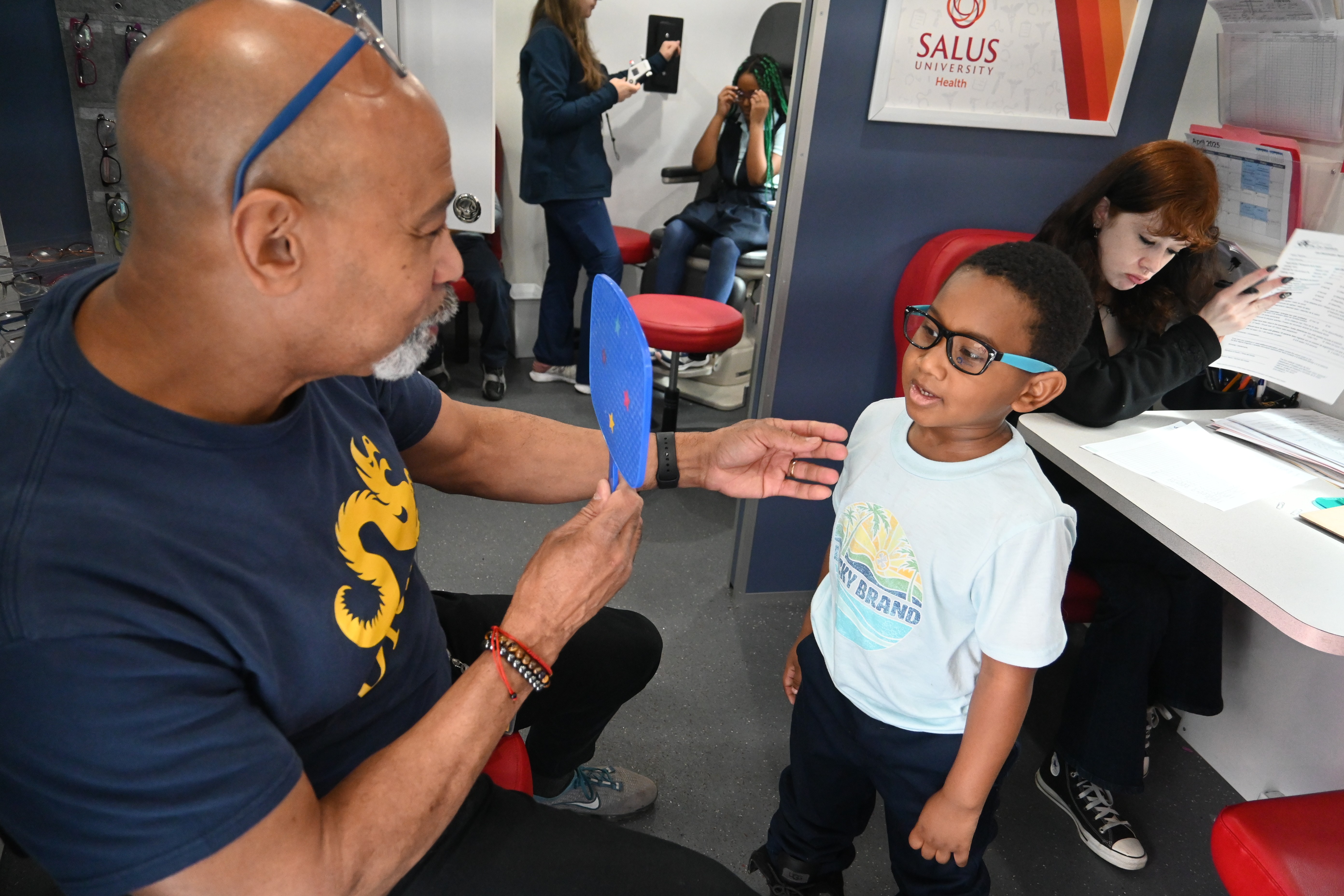 Stearne students tries on a pair of glasses