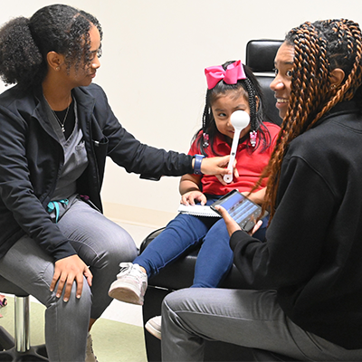 Optometric interns examining a child 