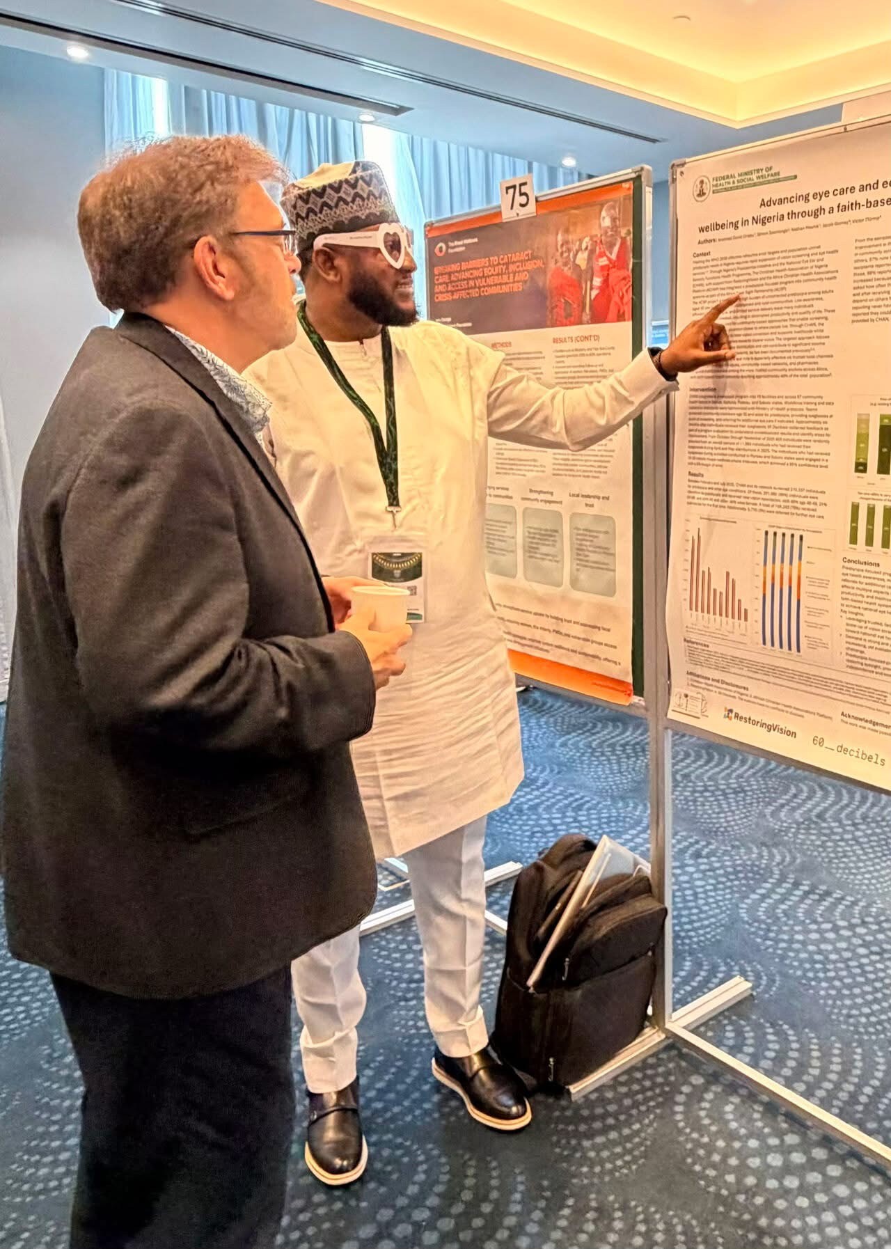 Dr. Weaver observing poster with a host