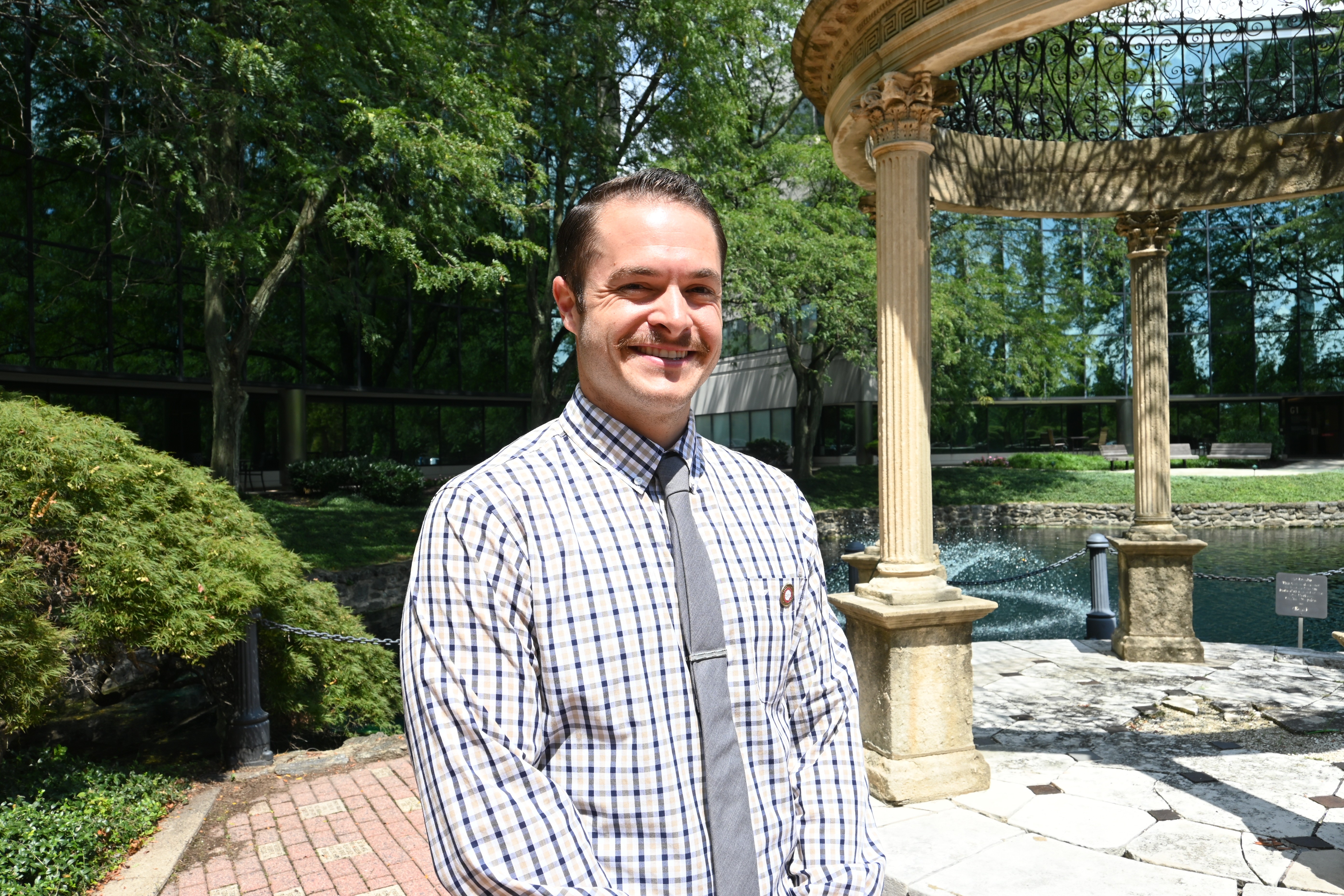 Zac Saunders on campus in front of the gazebo