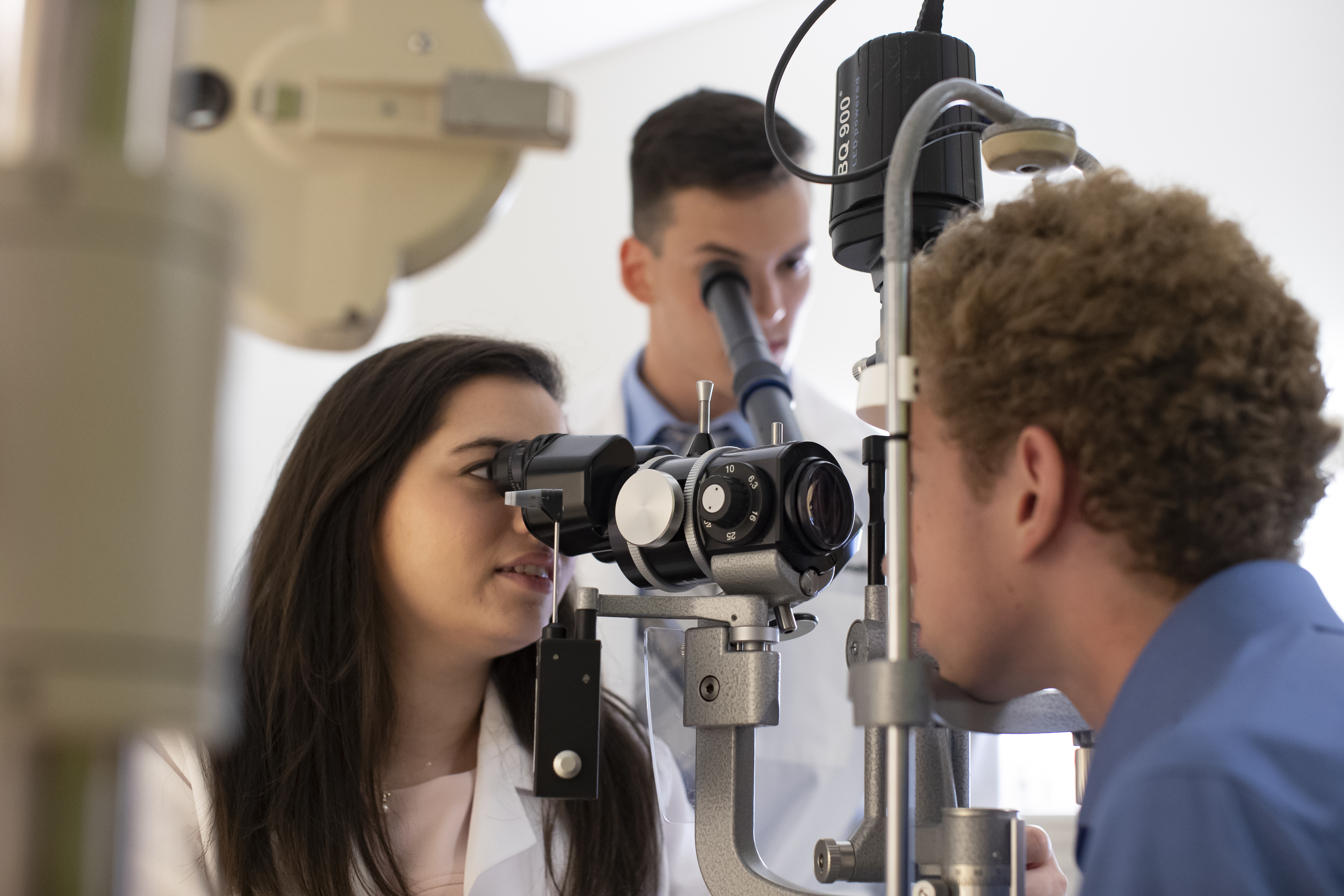 optometry students in the clinic performing eye exam