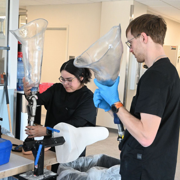 O&P students holding prosthetics