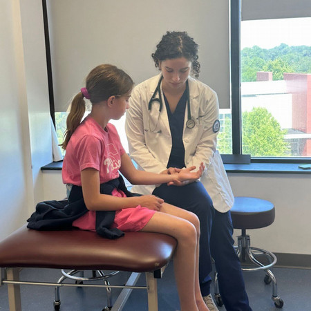 PA student examining pediatric patient