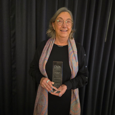 Jonette holding an award