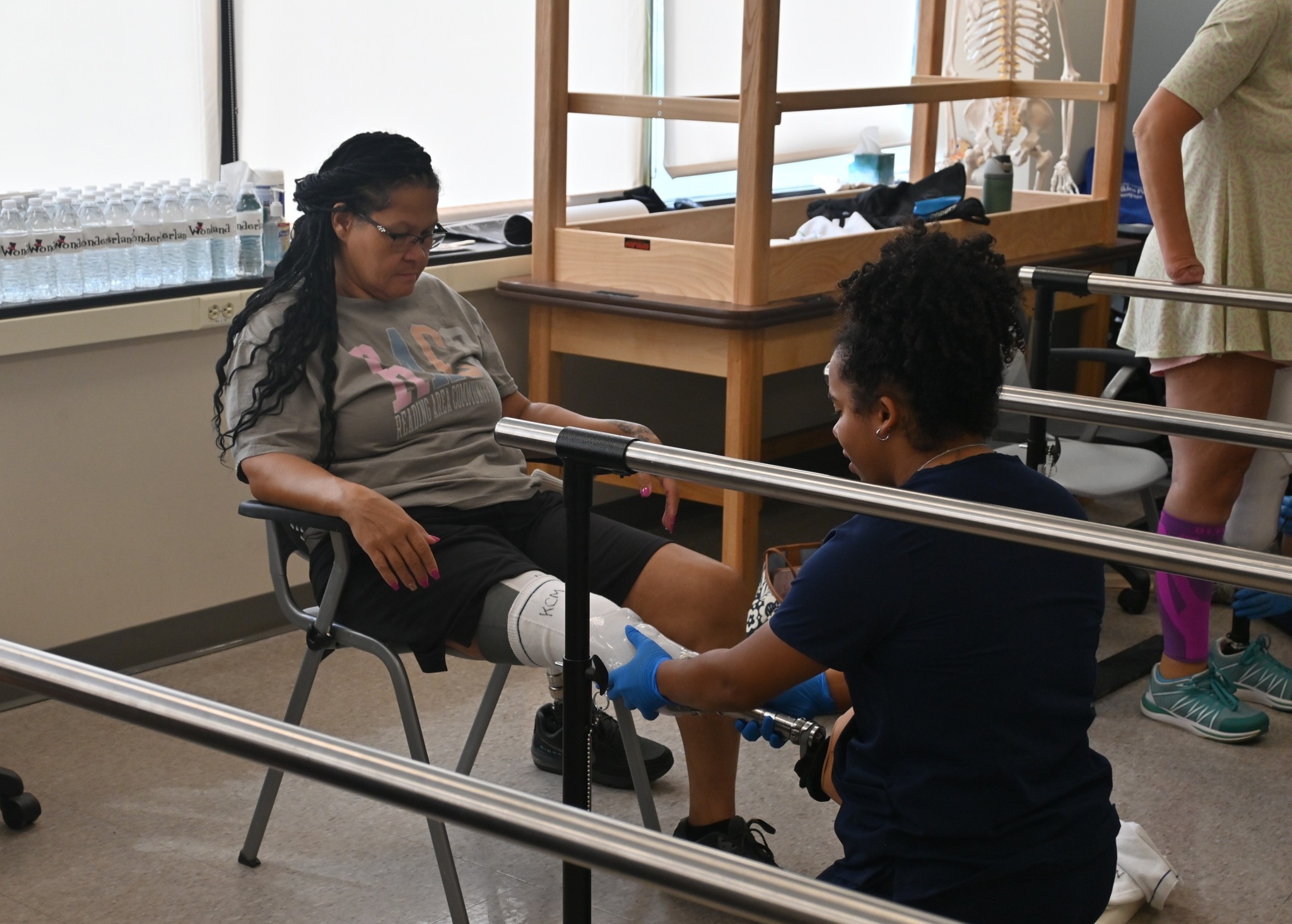 O&P student fitting prosthetic onto patient model