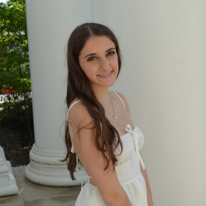 Jackie wearing a white dress