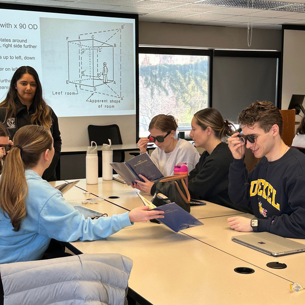 Optometry students wearing colored glasses