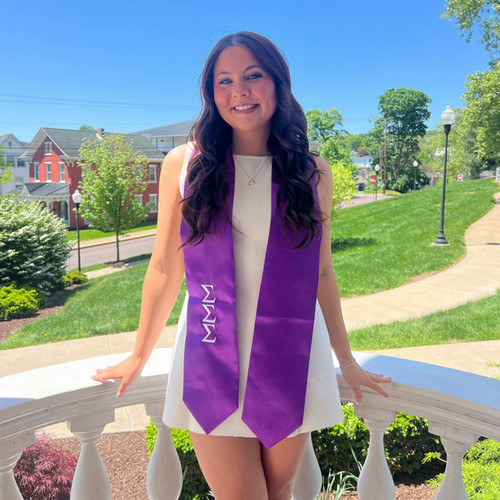student wearing a Greek letters sash