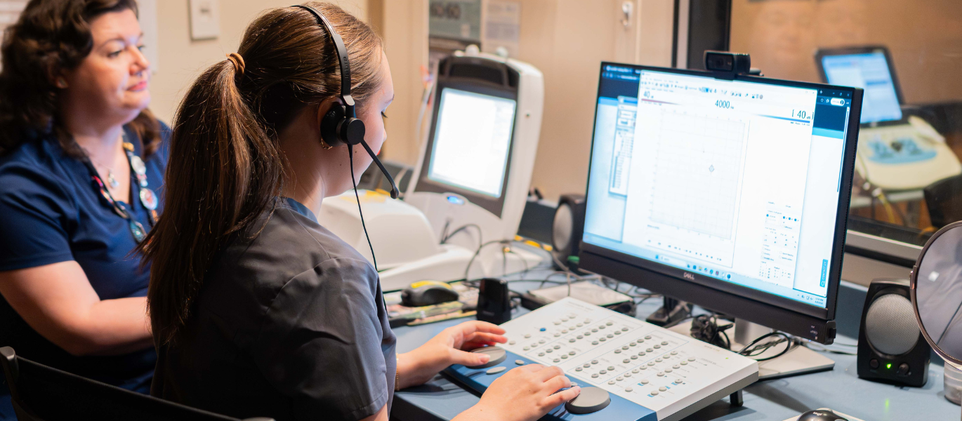 audiology student and faculty in clinic