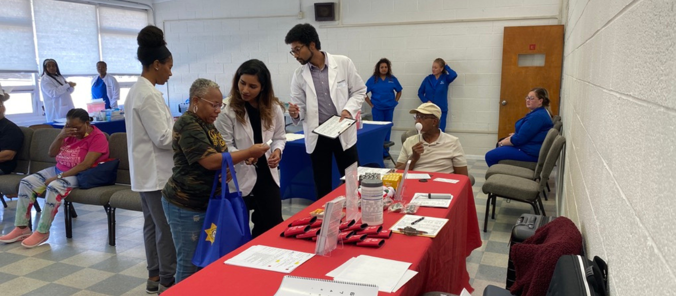 optometry students with patients at community event
