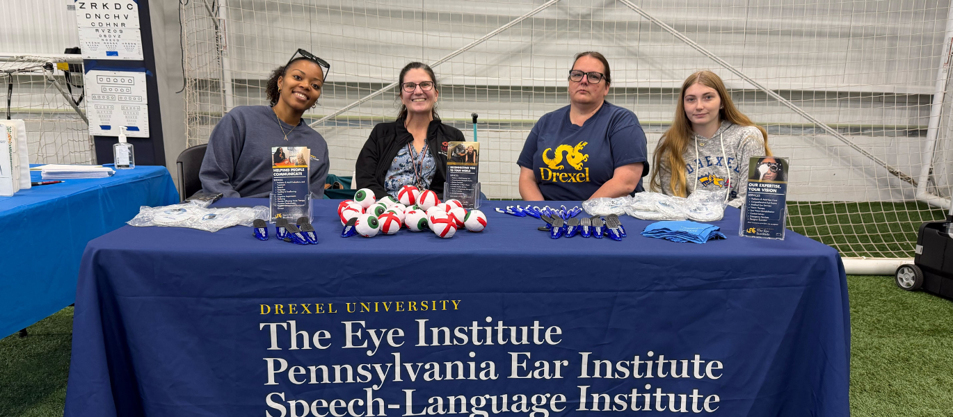 group photo of optometry faculty, staff, and students at community event