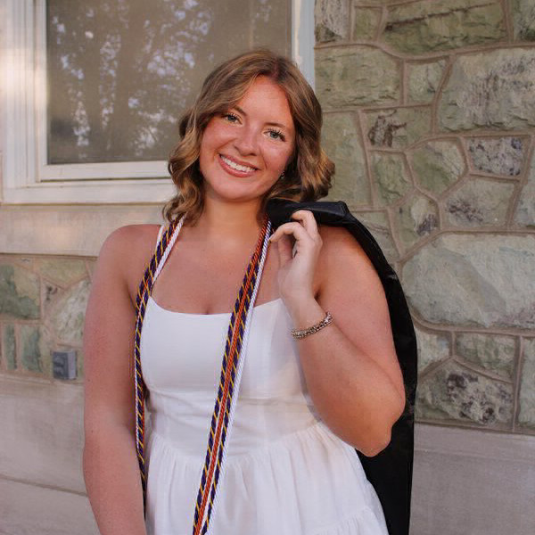 Cassidy wearing a white dress at graduation