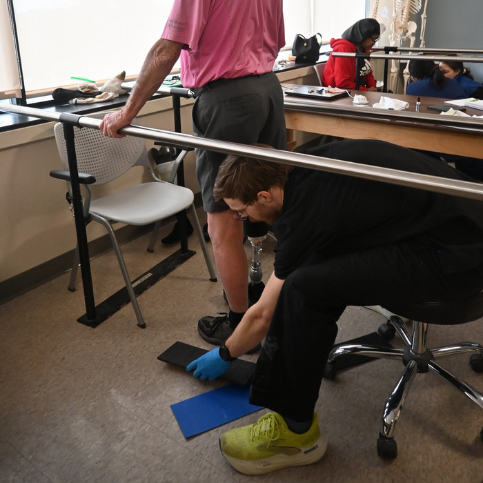 patient model and O&P student during fitting