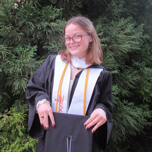 Riley wearing grad cap and gown