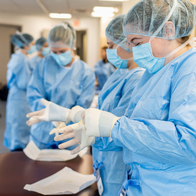 PA students practicing gowning and gloving