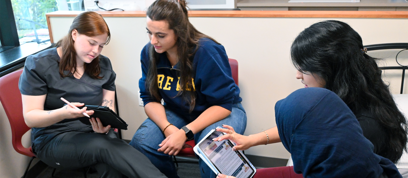 students looking a iPads